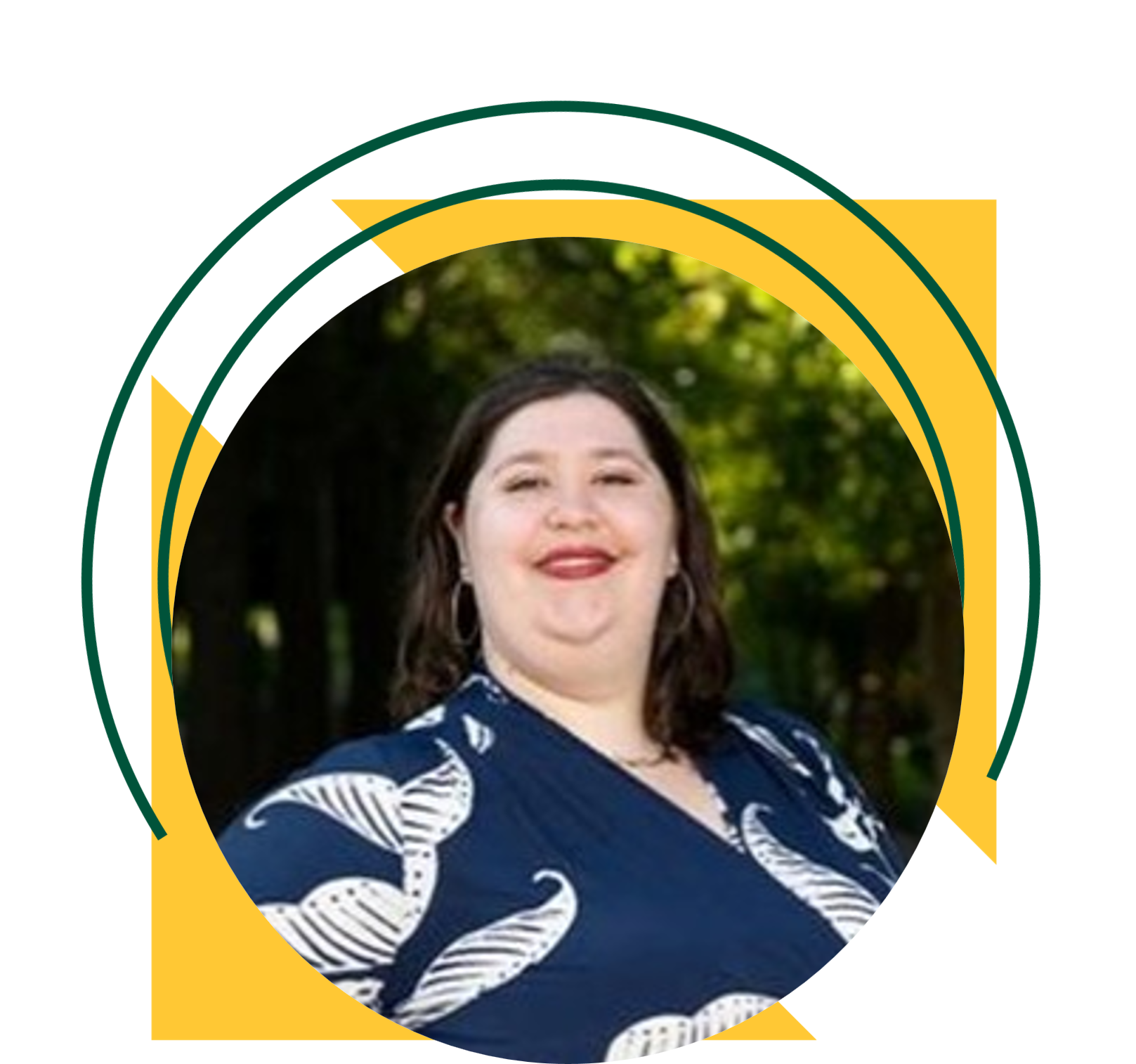 A woman smiling wearing a navy blue top and stands outdoors in front of green foliage. The portrait is framed within a circular design accented by yellow triangles and green graphic elements.